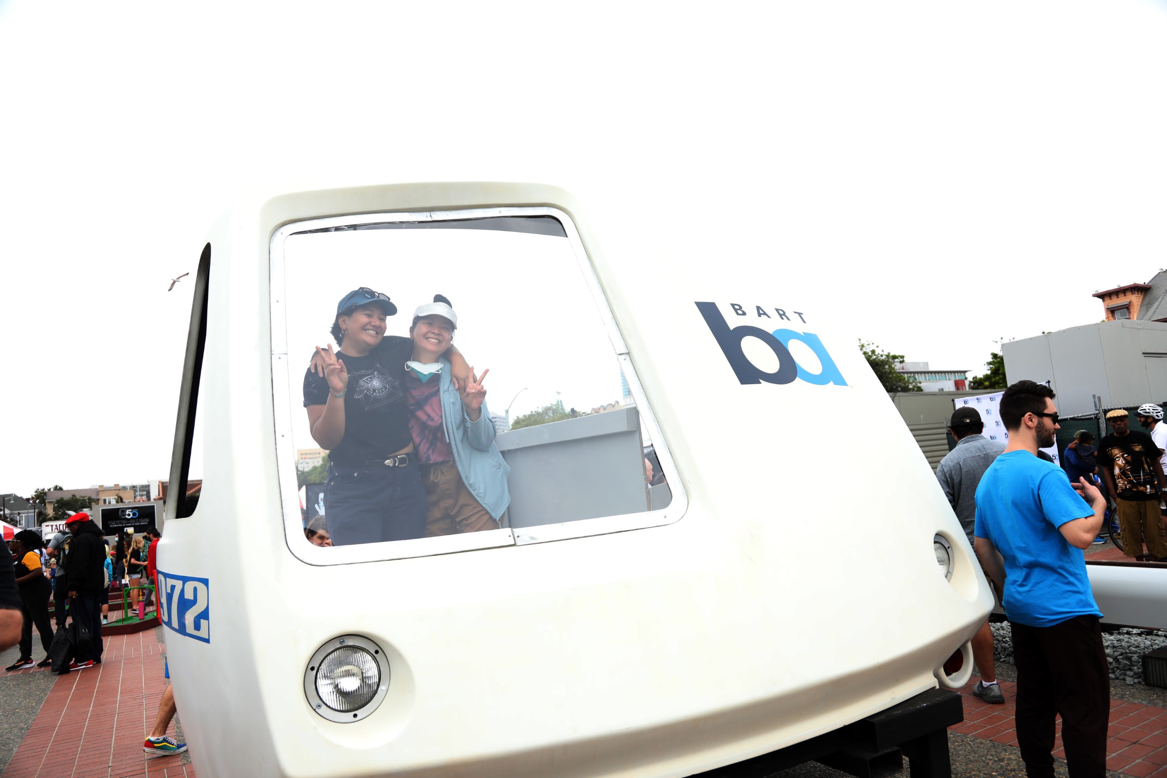 People pose in the nose of a train cab at BART’s 50th Anniversary Celebration and Family Fun Festival on Sept. 10, 2022. 