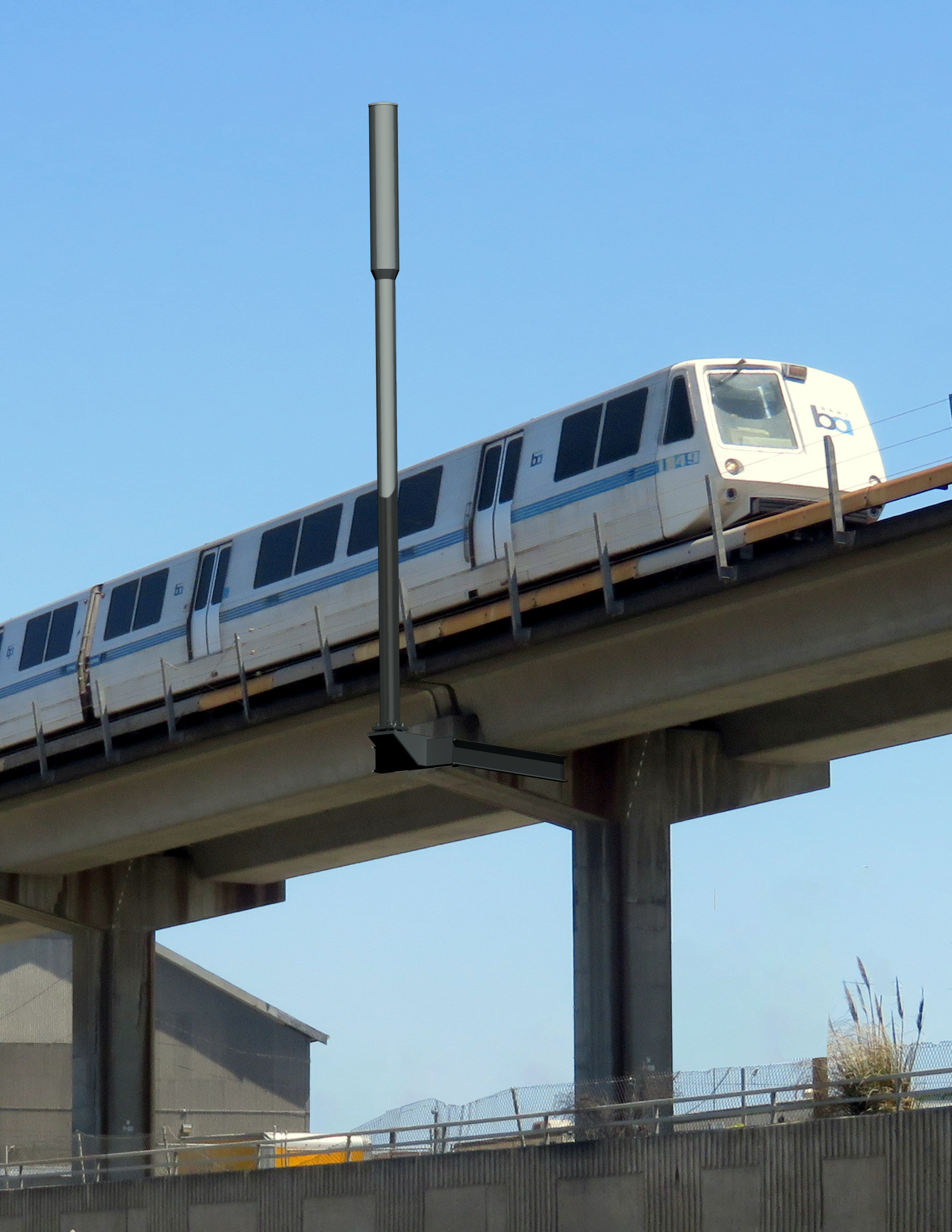 Wayside non-commercial pole shrouded and mounted on BART track