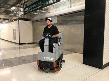 cleaning worker on power scrubber