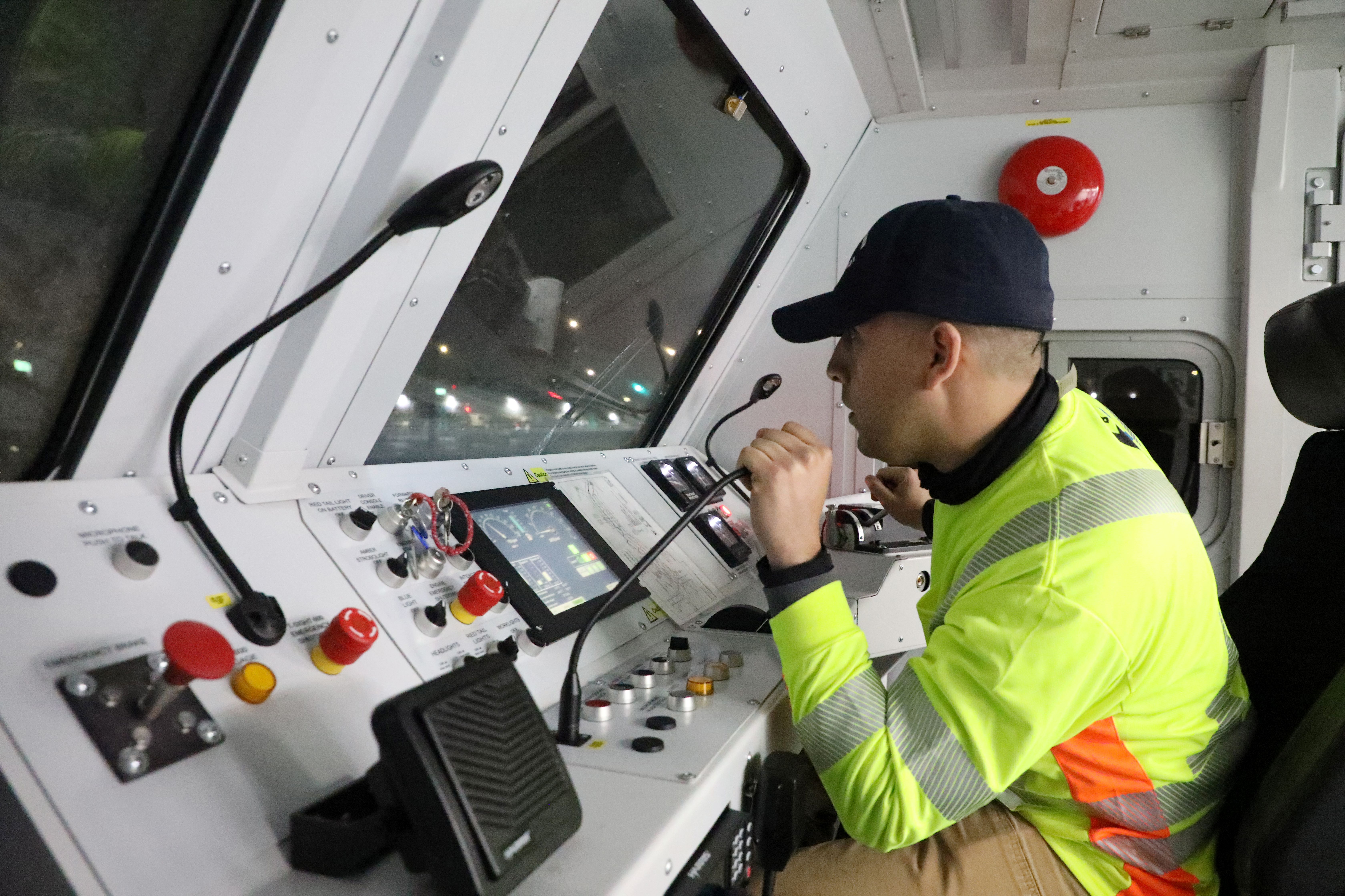 BART maintenance track worker communicates with staff while operating the Geo car