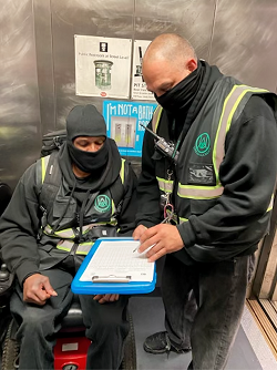 Stitt on his first day of work as an elevator attendant getting instructions from a supervisor