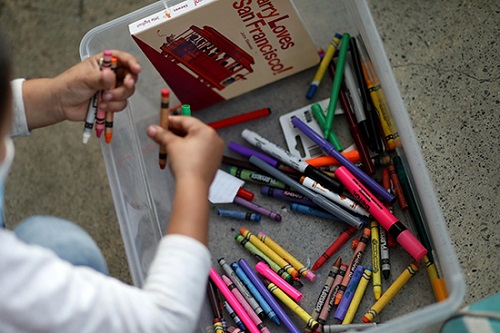 a child draws with crayons