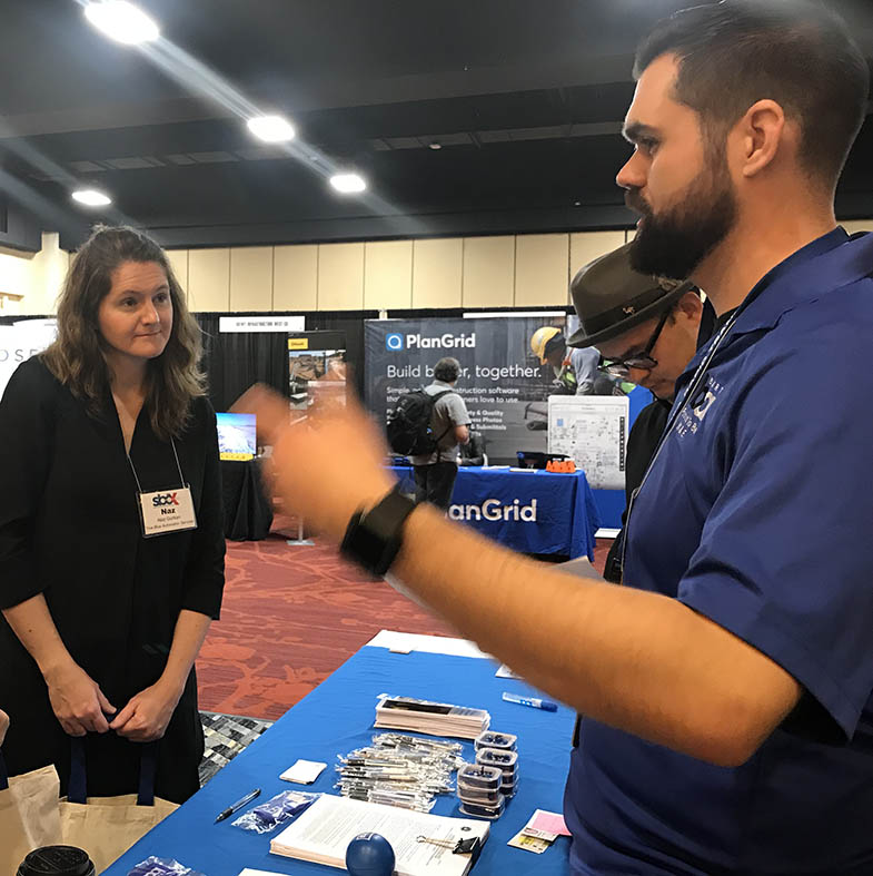 Christopher Wasilewski, a Manager of Engineering Programs, talks with a conference attendee