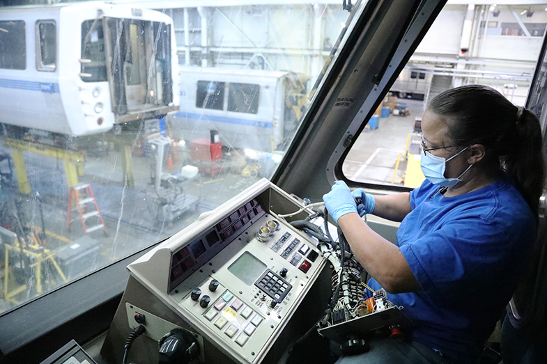 A worker removes components that will be stored as spare parts for other trains