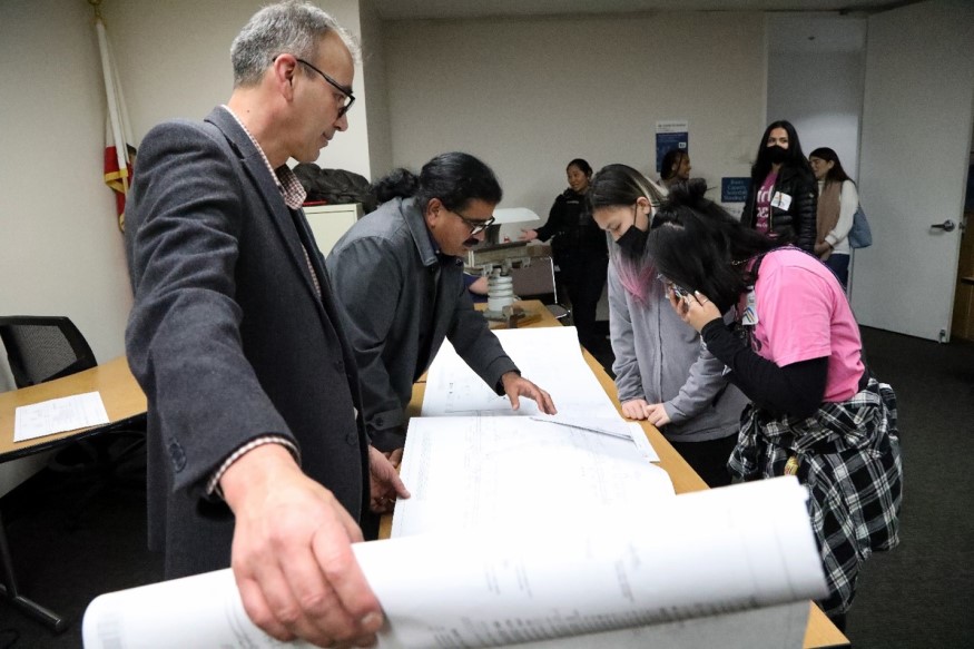 Juan Ulloa, Manager of Traction Power Engineering, and Balvir Thind, Project Manager in Power and Mechanical Engineering, show t