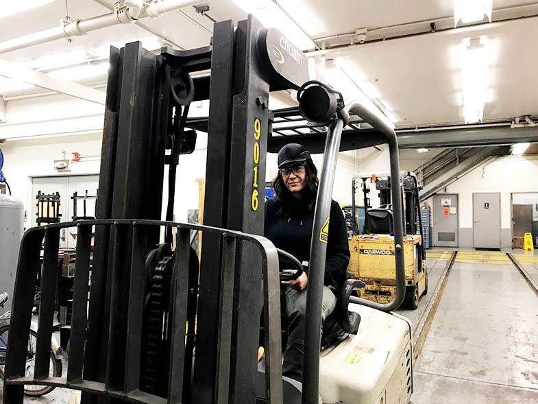 Expediter Janice Pelasauma on the forklift inside the Hayward Maintenance Shop