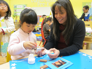 teacher Katryna Shek works with a student