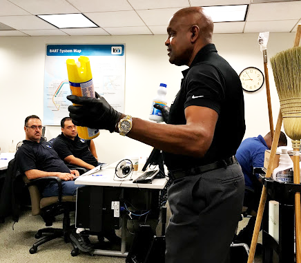 Ivey holds a can of Lysol in the training class 