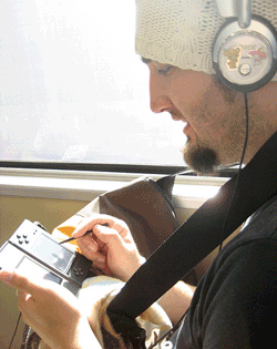 man playing portable game player on BART