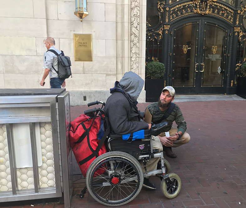 Veteran outreach specialist talks to man near BART