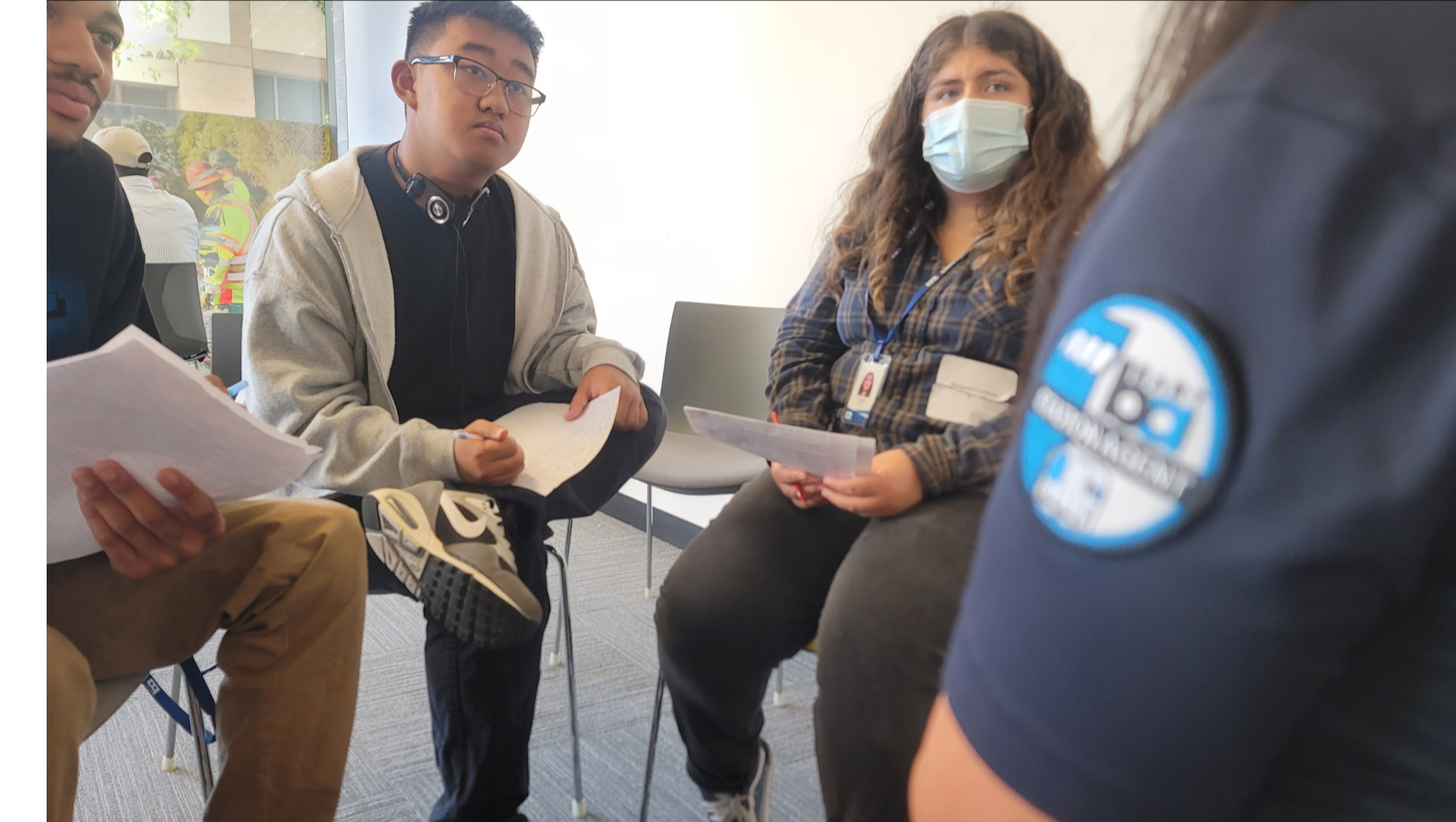 2024 speed networking day at BART photo of 3 interns listening to Station Agent