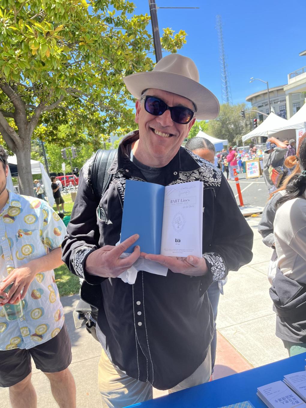 a happy customer poses with his chapbook