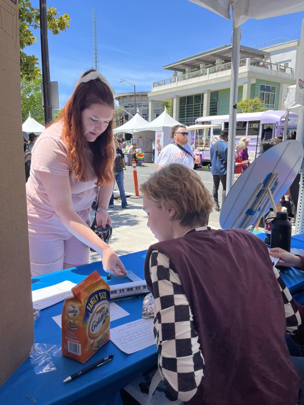 A poet assists a booth visitor