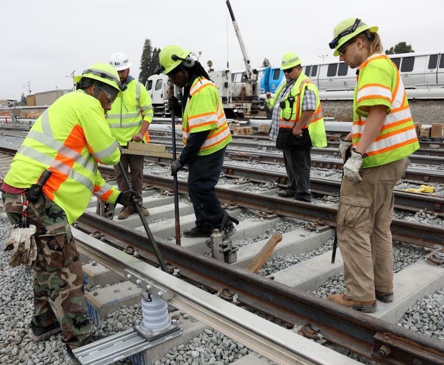 BART workers replacing aging rail.