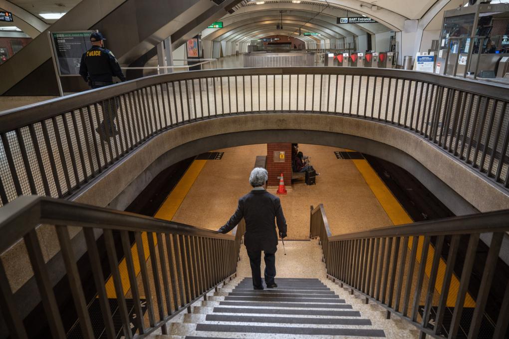 Person descending stairs at Downtown Berkeley Station.