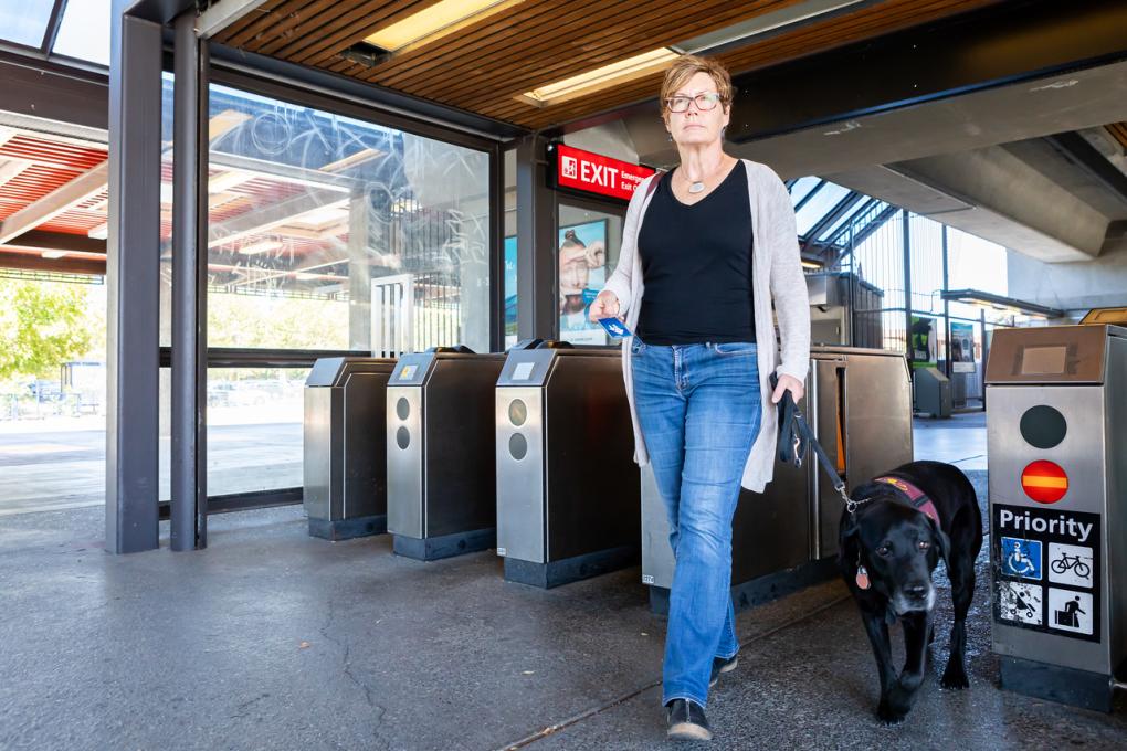 Kathleen Fraser and Handsome Ransom walk through the fare gates at Concord Station. 