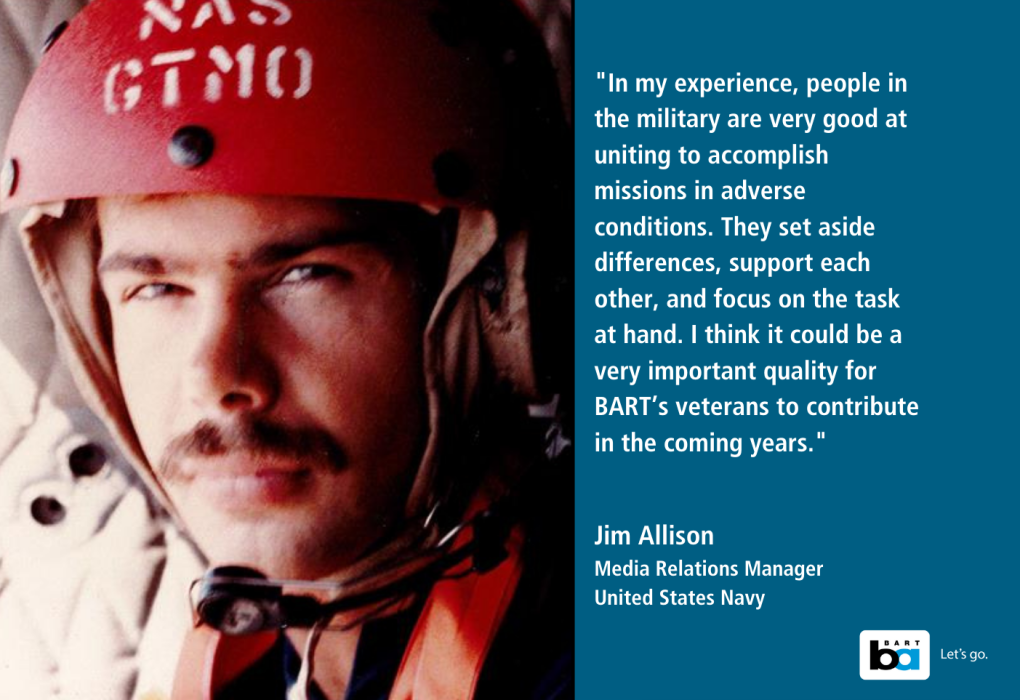 Portrait of a United States Navy pilot wearing a helmet with 'NAS' printed on it, featuring a quote about teamwork and mission success from Media Relations Manager Jim Allison.