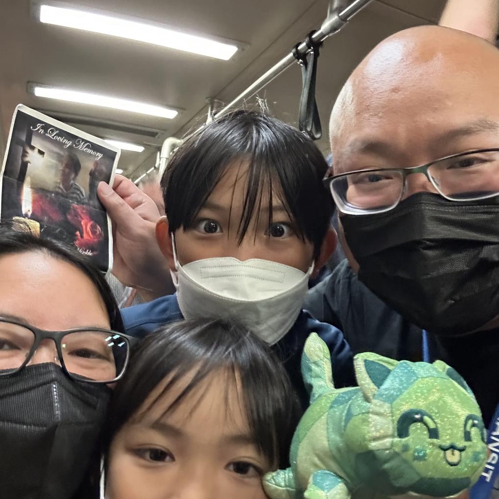 Mark Nagales and his family pose for a selfie on a BART train.