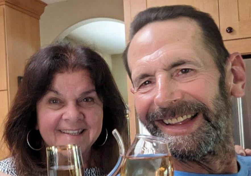 Cindy and Jeff smile in a recent photo with wine glasses