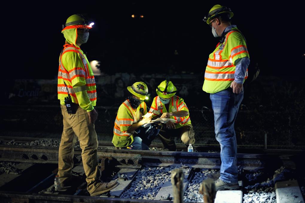 Engineers on the trackway at night.  